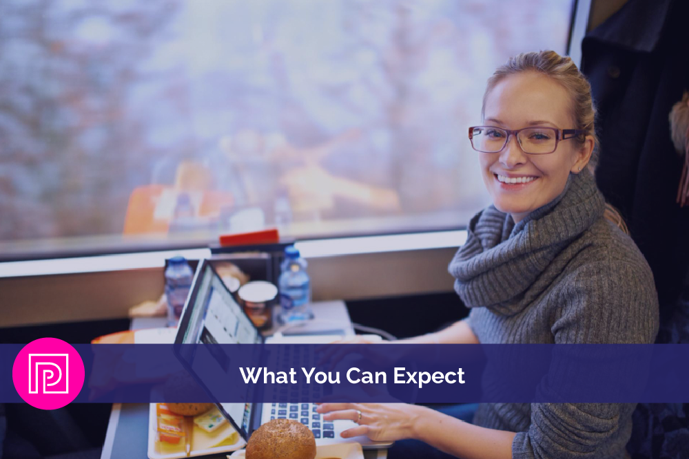 Smiling professional working on a laptop, representing a positive client experience and service expectations